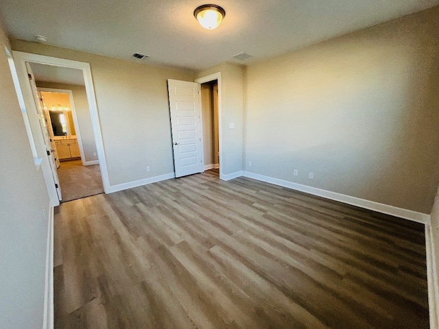 unfurnished bedroom with hardwood / wood-style flooring