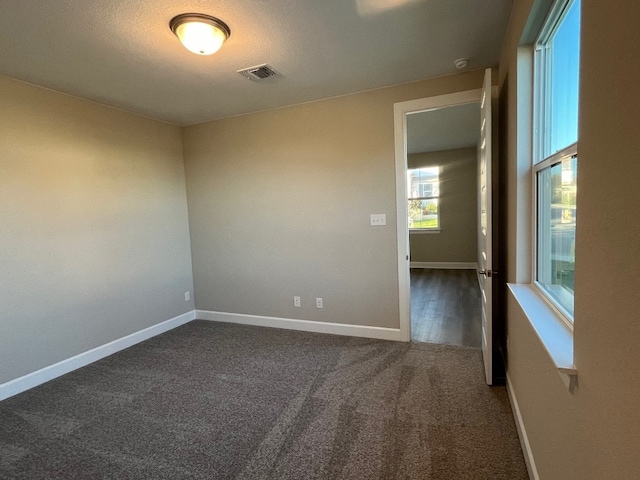 201 Alistair Dr, Georgetown, TX 78633 - spare room featuring dark carpet and baseboards