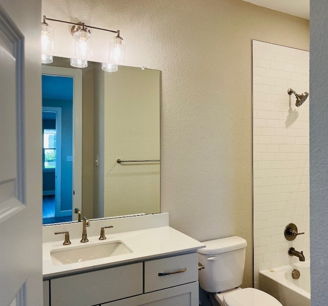 full bathroom featuring toilet, vanity, and tiled shower / bath