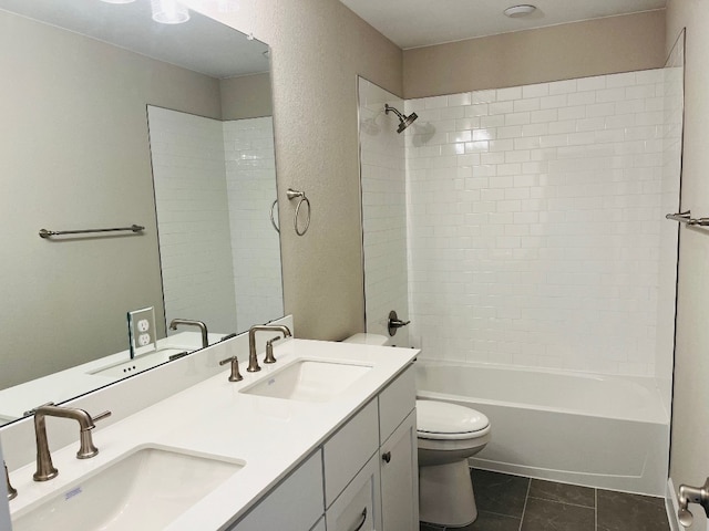 full bathroom with vanity, tile patterned floors, toilet, and tiled shower / bath combo