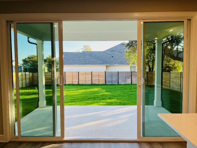 doorway with hardwood / wood-style flooring