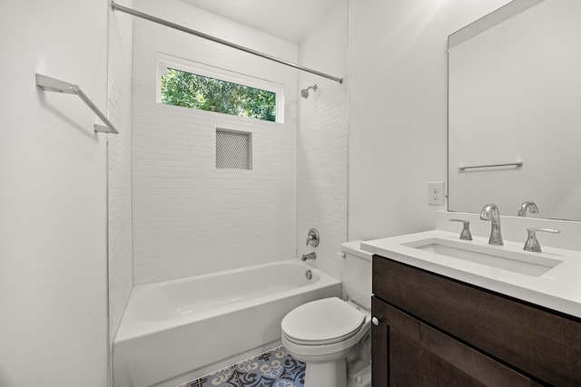 full bathroom with toilet, tiled shower / bath, and vanity