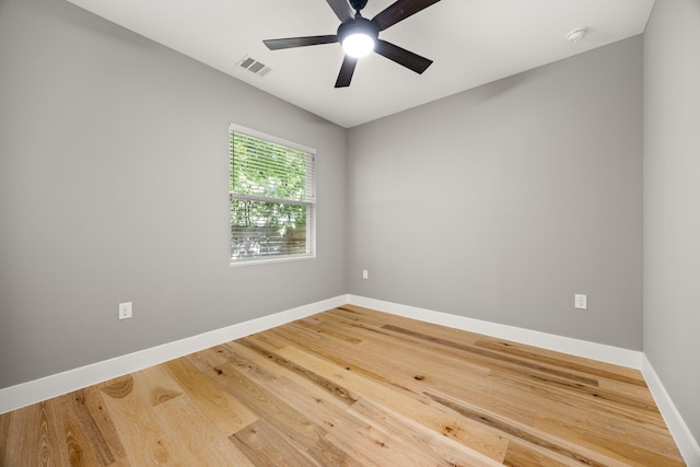 empty room featuring ceiling fan and hardwood / wood-style floors