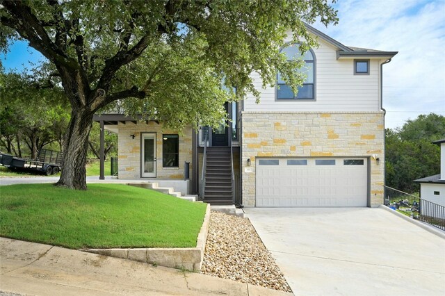 view of front facade featuring a garage and a front lawn