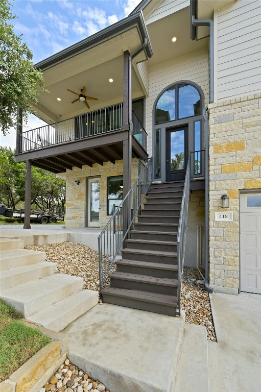 doorway to property featuring ceiling fan and a balcony