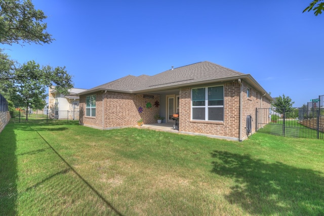 rear view of house featuring a yard and a patio