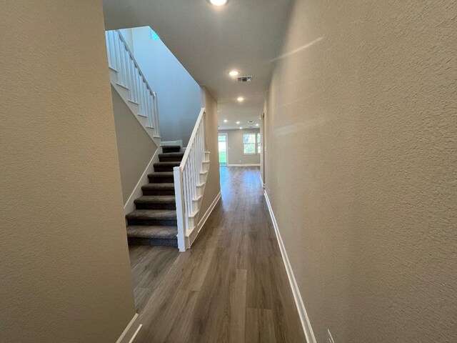 524 Raleigh Dr, Georgetown, TX 78633 - hall with dark wood finished floors, a textured wall, stairway, baseboards, and recessed lighting