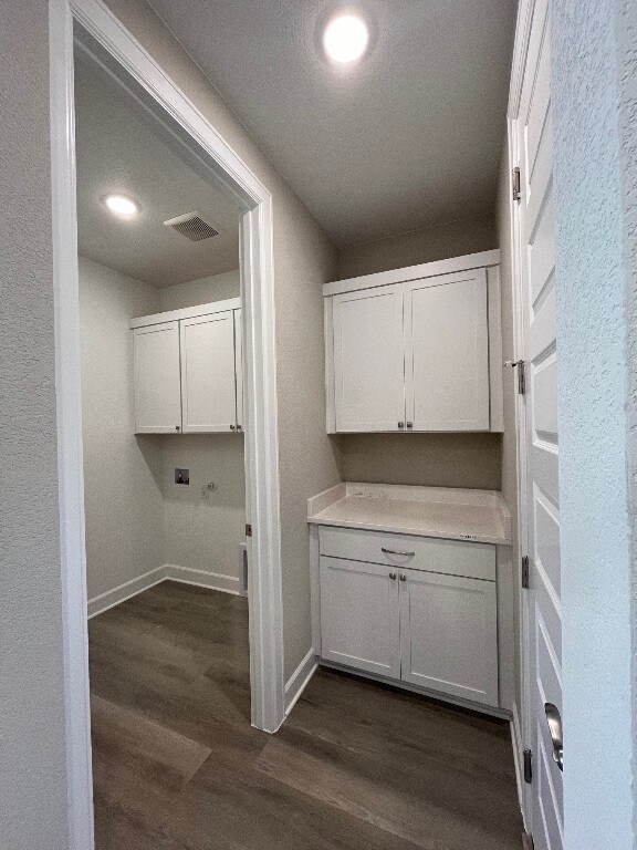 524 Raleigh Dr, Georgetown, TX 78633 - laundry room with dark wood-type flooring, baseboards, and recessed lighting