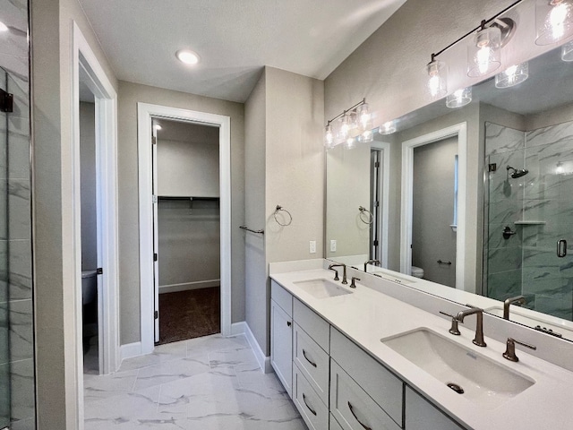 524 Raleigh Dr, Georgetown, TX 78633 - bathroom with toilet, marble look tile flooring, a marble finish shower, double vanity, and baseboards