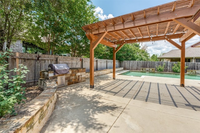 view of patio / terrace with a pergola, a grill, and an outdoor kitchen