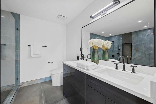 bathroom with vanity, a shower with shower door, and toilet