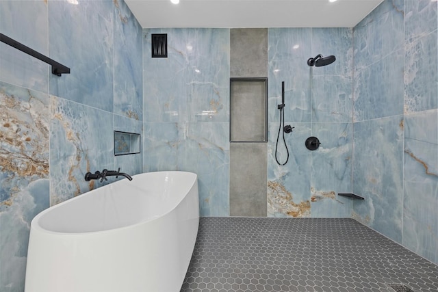 bathroom with tile walls and separate shower and tub