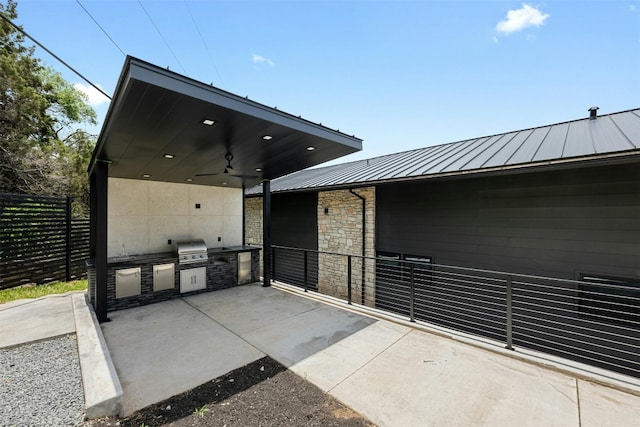 view of patio / terrace with exterior kitchen, grilling area, and ceiling fan