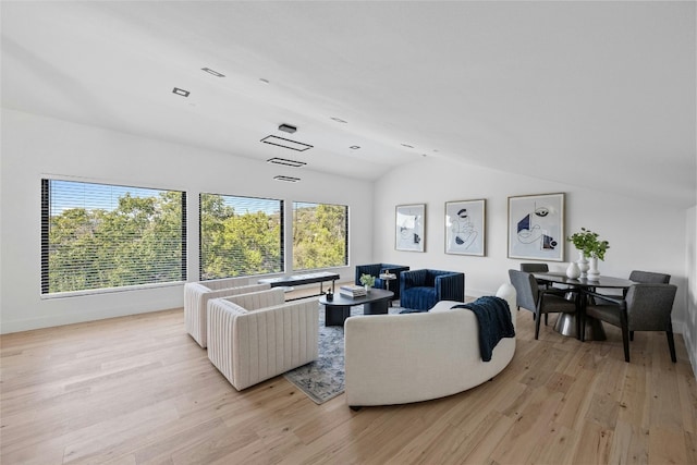 living room featuring light wood-type flooring and vaulted ceiling