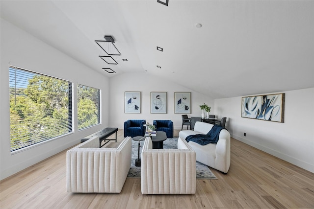 living room featuring vaulted ceiling and light wood-type flooring