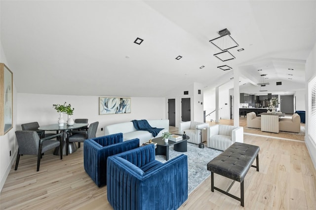 living room with lofted ceiling and light hardwood / wood-style flooring