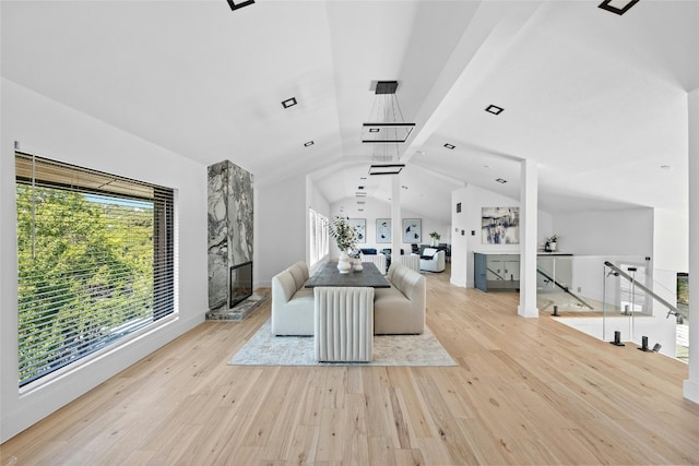 unfurnished living room with lofted ceiling and light wood-type flooring