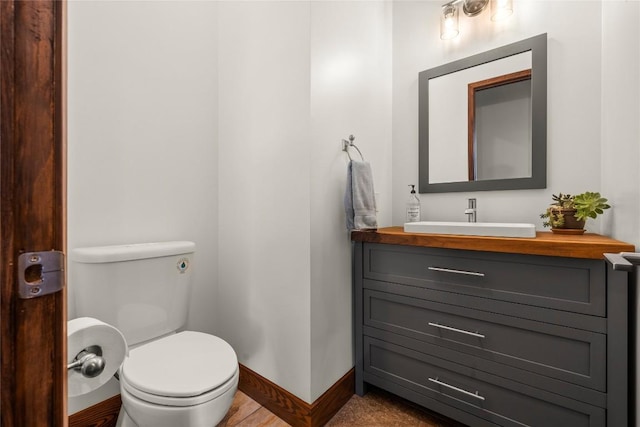 bathroom featuring toilet and vanity