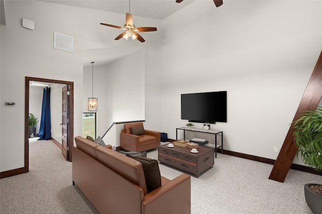 carpeted living room featuring ceiling fan and high vaulted ceiling