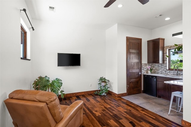 living room featuring ceiling fan, sink, plenty of natural light, and light wood-type flooring