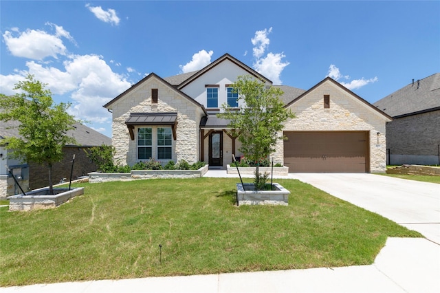 view of front of house featuring a front yard and a garage