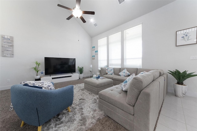 tiled living room featuring ceiling fan and high vaulted ceiling