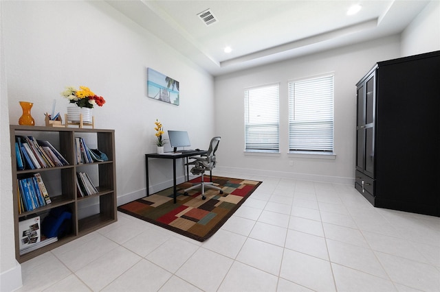 home office featuring a raised ceiling and light tile patterned floors