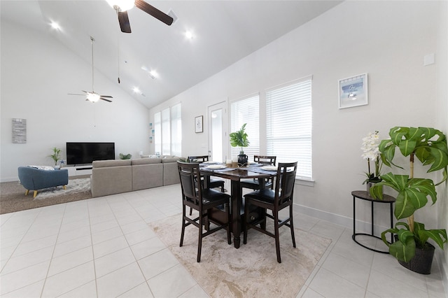 tiled dining room featuring high vaulted ceiling and ceiling fan