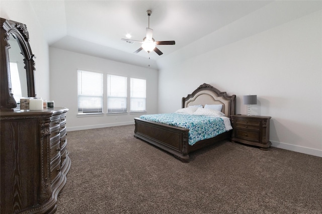 bedroom featuring lofted ceiling, dark carpet, and ceiling fan