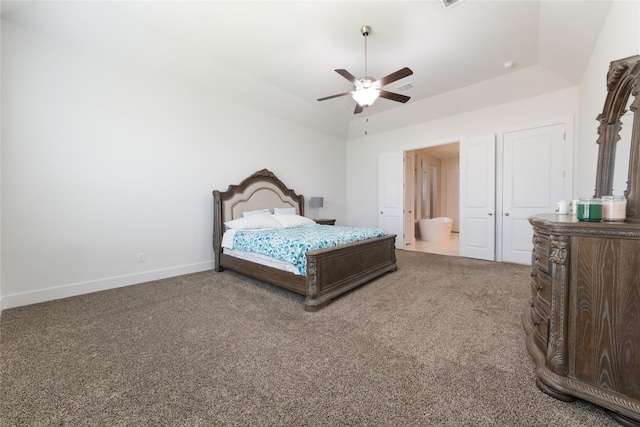 carpeted bedroom with ceiling fan, vaulted ceiling, and a tray ceiling