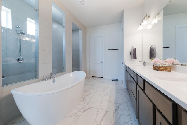 bathroom featuring vanity and independent shower and bath