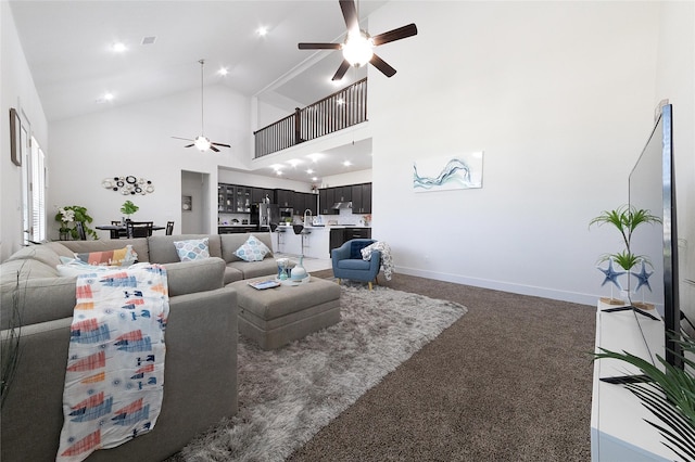 carpeted living room featuring ceiling fan and high vaulted ceiling