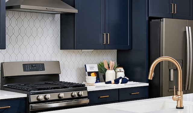 kitchen featuring decorative backsplash, stainless steel appliances, ventilation hood, and blue cabinets