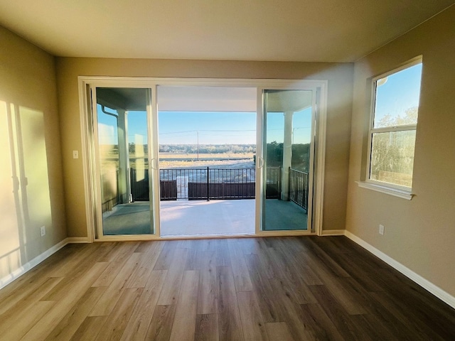 unfurnished room featuring hardwood / wood-style flooring