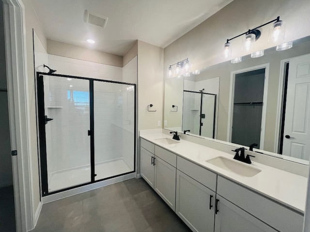 bathroom featuring vanity and an enclosed shower