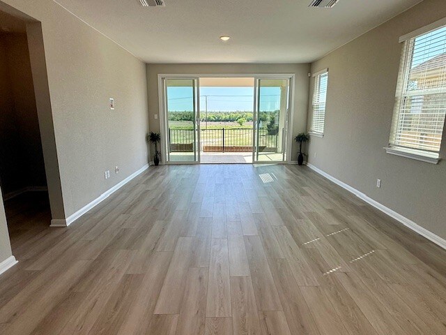 533 Raleigh Dr, Georgetown, TX 78633 - unfurnished room with healthy amount of natural light, wood finished floors, and baseboards