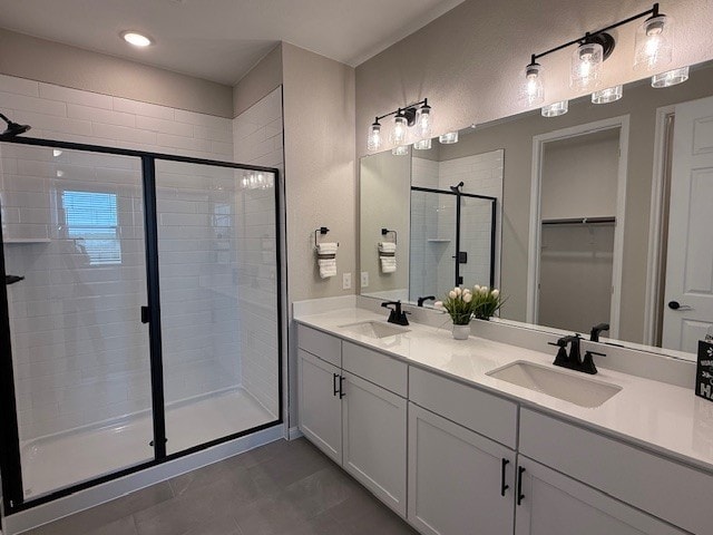533 Raleigh Dr, Georgetown, TX 78633 - bathroom with a shower stall, double vanity, a walk in closet, and tile patterned flooring