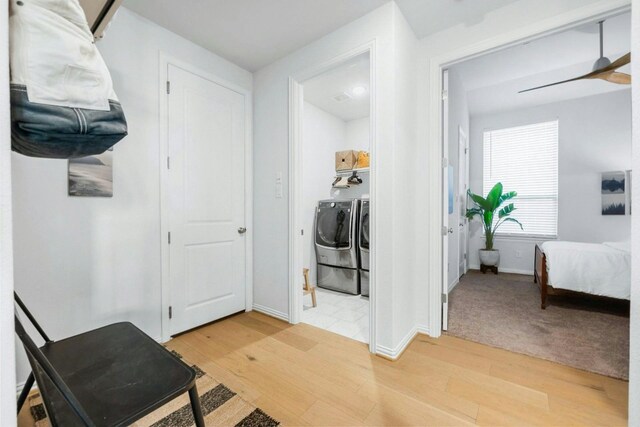 hall featuring wood-type flooring and washer and dryer