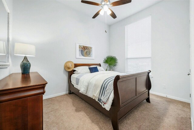 bedroom with light carpet and ceiling fan