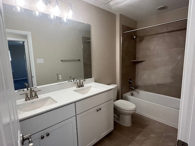 540 Raleigh Dr, Georgetown, TX 78633 - bathroom featuring toilet, tile patterned flooring, double vanity, shower / bathtub combination, and a textured wall