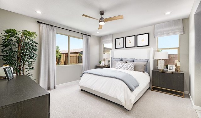 bedroom with ceiling fan and light carpet