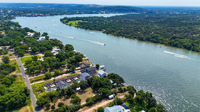 drone / aerial view featuring a water view and a view of trees