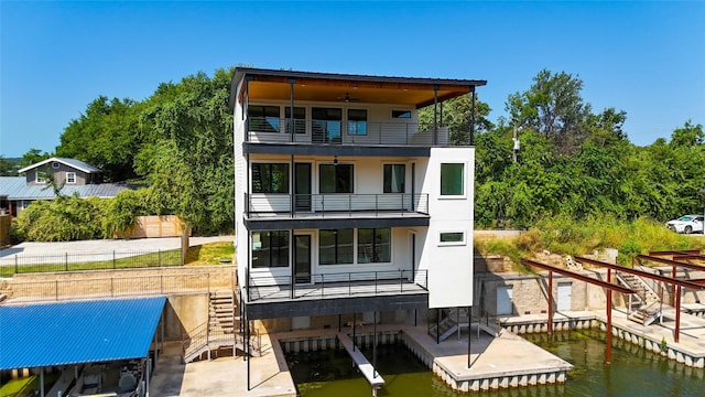 back of house with a balcony, ceiling fan, stairs, and a patio