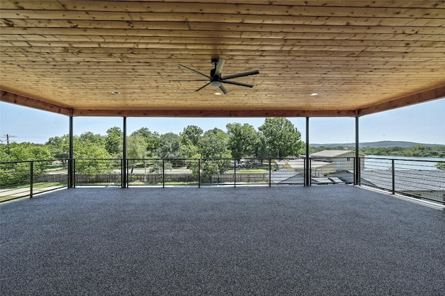 unfurnished sunroom featuring ceiling fan and wooden ceiling