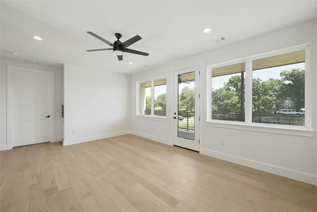 spare room with light hardwood / wood-style floors and ceiling fan