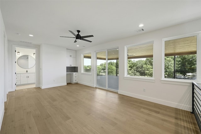 unfurnished living room featuring ceiling fan and light hardwood / wood-style floors