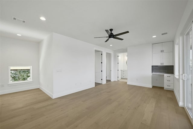 unfurnished living room featuring light hardwood / wood-style floors and ceiling fan