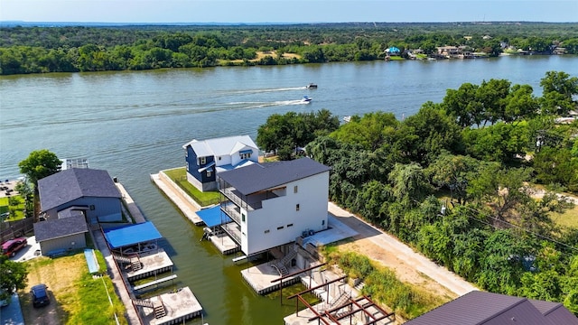 aerial view featuring a water view and a forest view