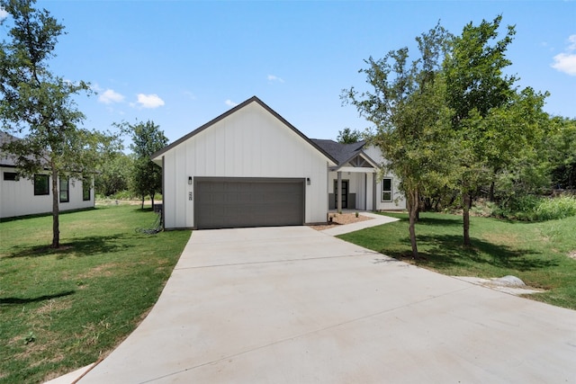 modern inspired farmhouse with a garage and a front lawn