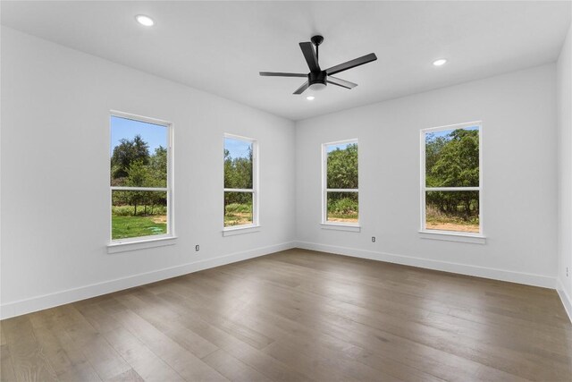 spare room with ceiling fan and dark hardwood / wood-style flooring